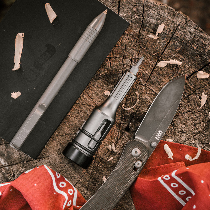Bit Driver Grande bit driver tool laid out with knife and driver bits