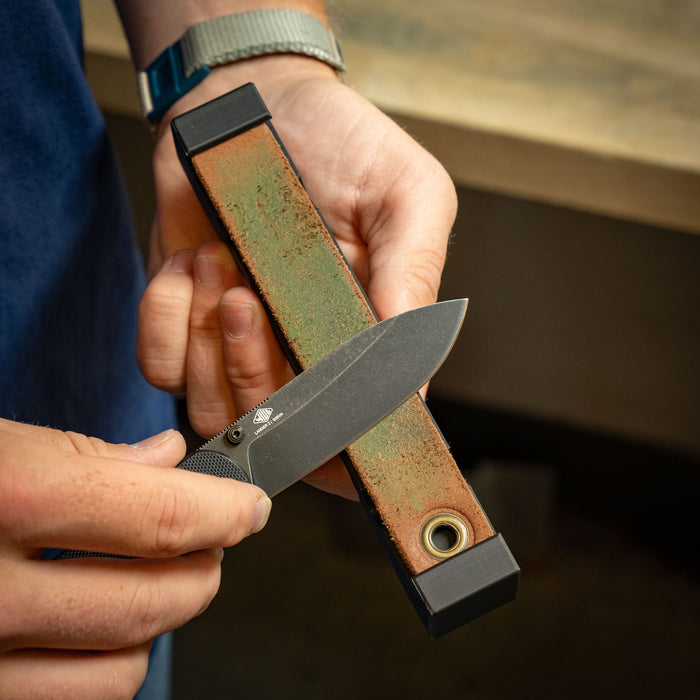 Loaded Docking Station Sharpening Bundle sharpening tool held in hand outdoors